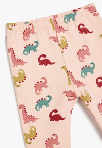 Różowe legginsy dziecięce z kolorowymi wzorami dinozaurów w kolorach zielonym, czerwonym, musztardowym i różowym, z elastycznym pasem i miękkiego materiału.