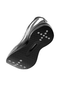 Semelle de chaussure de sport en noir et blanc présentant un motif texturé, plusieurs points de grip circulaires et une zone en retrait au centre.