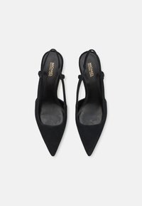 Black suede slingback heels with pointed toes, side cutouts, and narrow straps. Interior features gold branding on a smooth insole.