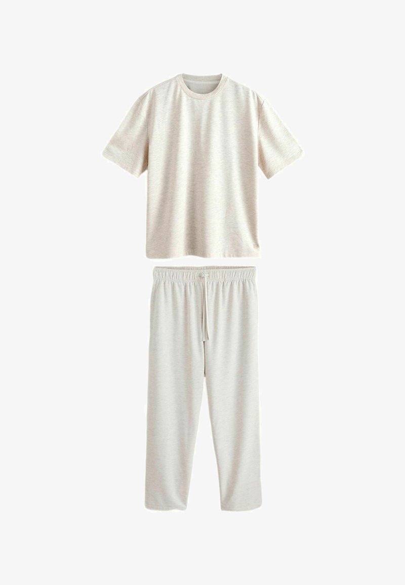 Ensemble composé d'un T-shirt à manches courtes beige clair et d'un pantalon à taille élastique avec cordon de serrage, présenté à plat sur fond blanc.