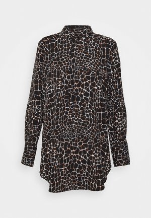 Long-sleeve black shirt with brown and white irregular giraffe-like spots, with button-up collar and curved hem.