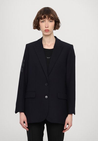 Navy blazer made of smooth fabric, featuring a two-button closure, notched lapels, two front pockets, and subtle embellishment on the sleeve.
