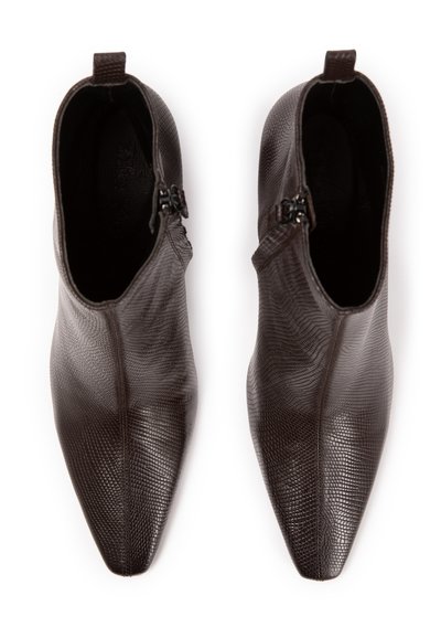 Brown leather ankle boots with a textured finish, pointed toe, side zippers, and a low-cut design. Designed for a fitted look.