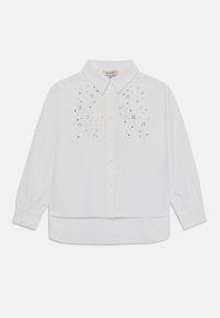 White button-up shirt with long sleeves, featuring a subtle sequin pattern on the front and a rounded hem. Made from a lightweight fabric.