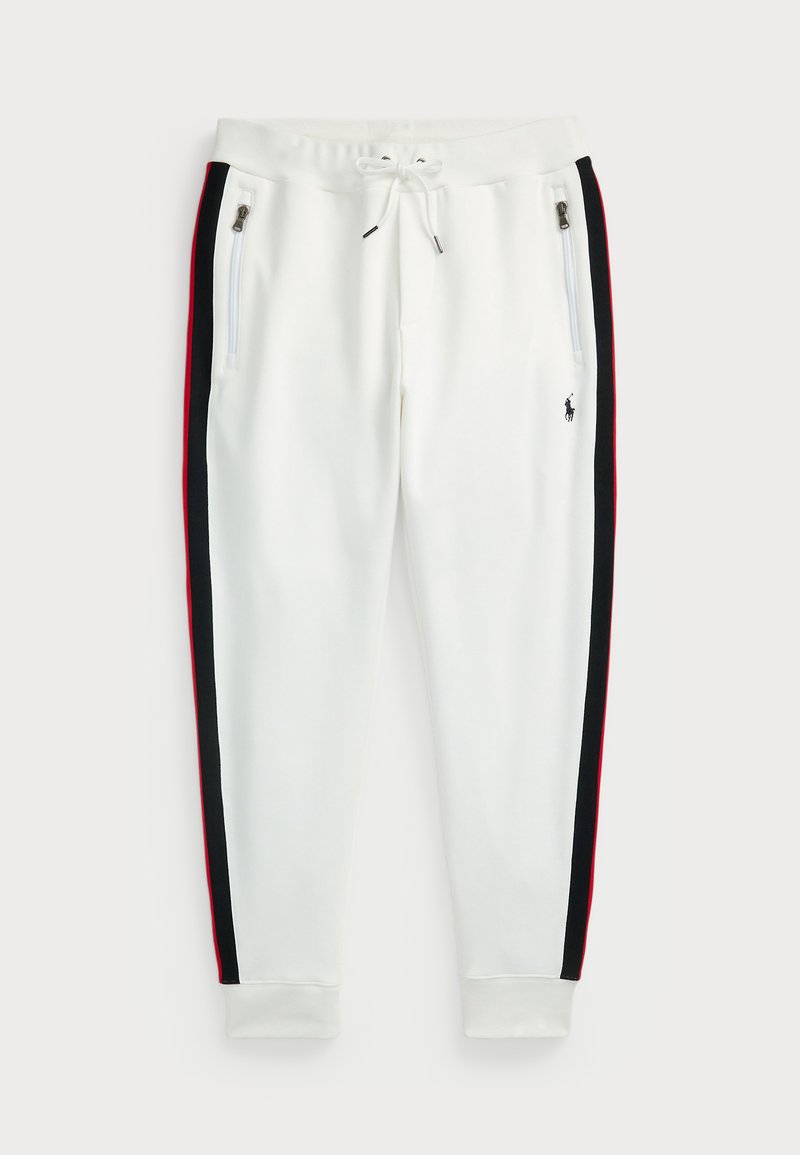 Valged sportpüksid mustade ja punaste külgtriipudega, elastne vöökoht koos paelaga, taskutel lukud ja esiküljel tikandiga logo.