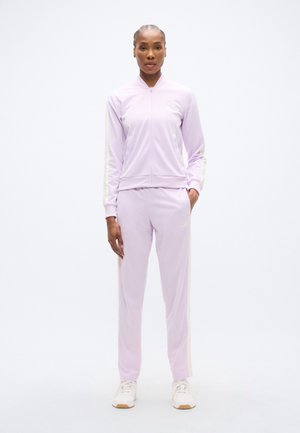 Világos lila melegítő sima anyagból, cipzáras dzsekivel és hozzáillő nadrággal. Fehér csíkok díszítik az ujjakat és az oldalakat.