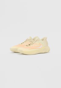 Beige athletic shoes featuring wavy orange and white patterns, textured sole, and a padded collar for support.