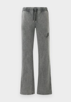 Pantaloni da jogging ampi in grigio sbiadito con vita elasticizzata e lacci neri, caratterizzati da una piccola ricamatura nera sulla coscia destra.
