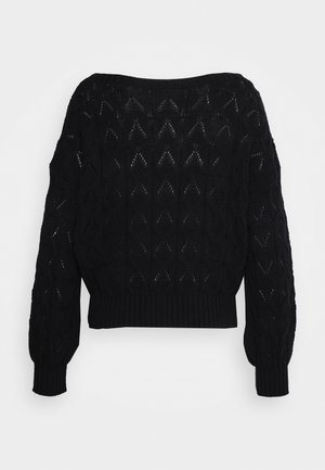 Pull noir en tricot avec un motif texturé en formes de diamants, manches larges et design court. Poignets et ourlet côtelés.