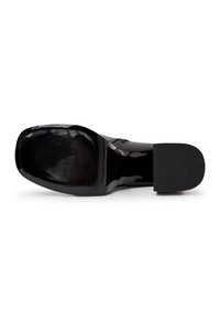 Black patent leather shoe with a smooth, shiny surface and a textured rubber sole. Features a square toe and minimalist design.