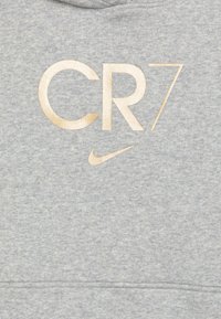Grauer Hoodie mit goldener "CR7"-Logo und Nike-Swoosh. Weicher, strukturiertes Material mit Kapuze mit Kordelzug und Kängurutasche.