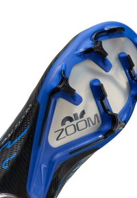 Black and blue athletic shoe outsole featuring six studded spikes, a textured surface, and "Air Zoom" branding in silver.