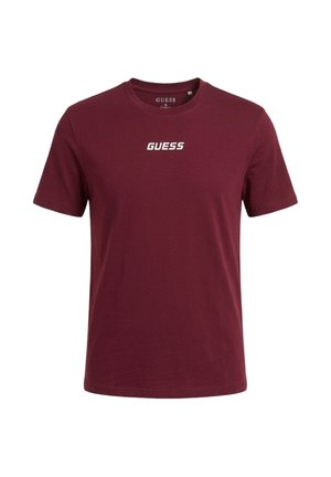 T-shirt bordeaux a maniche corte con scollo tondo e logo bianco "GUESS" al centro del petto, taglia piccola.