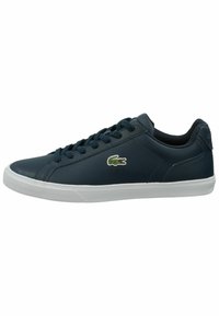 Navy blue leather sneakers with white rubber sole, featuring round toe, lace-up design, and green embroidered crocodile logo on side.