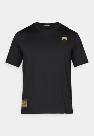 Black cotton t-shirt with short sleeves, featuring an orange snake logo on the upper left and a patterned accent on the bottom left.