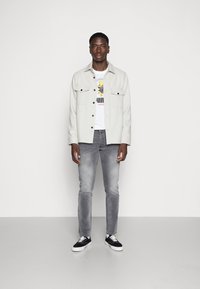 Puma PUMA HARIBO GRAPHIC TEE - Triko s potiskem - puma white