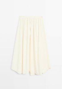 Jupe midi couleur crème avec un design plissé. Fabriquée dans un tissu léger, elle présente une taille élastique et un ourlet arrondi.