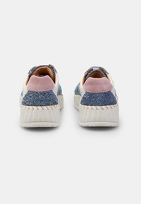 Sneaker blu e rosa pallido con tomaia texturizzata, suola bianca e collo imbottito. La cucitura visibile lungo la suola aggiunge dettaglio.