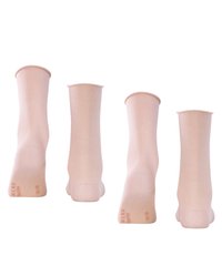 Beige mid-calf socks made of soft, stretchy material with a smooth texture. Feet shown from various angles, displaying the heel and toe areas.