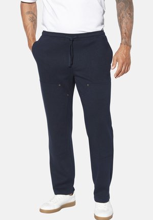 Navy blue sweatpants made of soft fabric, featuring a drawstring waistband, two front pockets, and subtle stitching details.