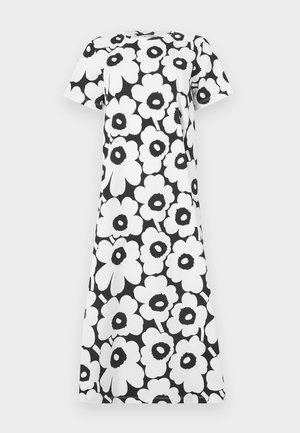 Melnā un baltā kleita ar īsām piedurknēm, lielu izteiksmīgu ziedu rakstu un taisnu, brīvu piegriezumu.