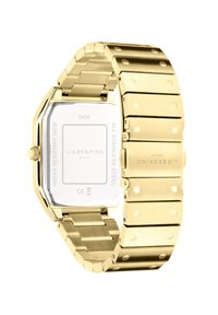 Orologio in acciaio inossidabile dorato con cassa ottagonale, finiture opache e lucidate, bracciale con maglie regolabili e fondello in vetro trasparente che mostra i dettagli del brand.