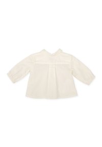 Blusa de marfil claro con mangas largas, diseño de espalda plisada, textura suave de algodón y un pequeño cuello alzado. Sin patrones ni acentos visibles.