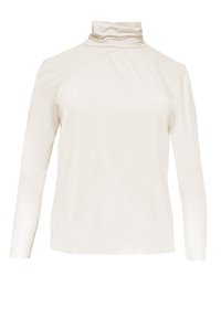 Cream-colored long-sleeve top with a high, folded collar. Features a smooth, slightly glossy texture and diagonal seam detail on one side.