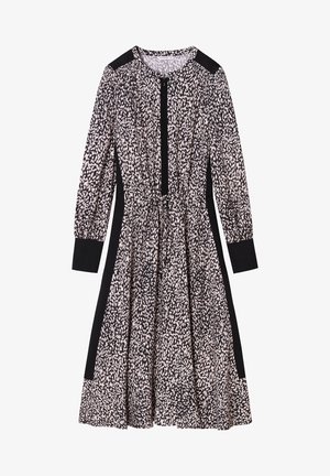 Sukienka o długości do kolan z długim rękawem, w abstrakcyjne czarno-białe plamy, z czarnymi mankietami, panelami na ramionach, panelami bocznymi oraz zamkiem błyskawicznym z przodu.