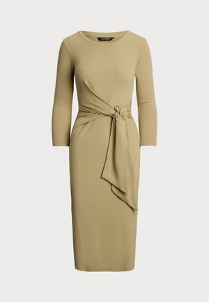 Long-sleeve, knee-length dress in soft beige fabric. Features a knotted waist detail and a round neckline with a fitted silhouette.