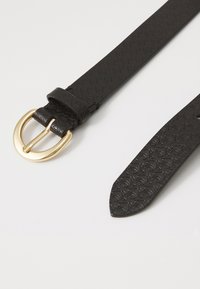 Black leather belt with embossed pattern, featuring a round gold-tone buckle, smooth texture, and tapered end for adjustable fitting.