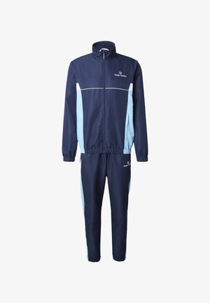 Donkerblauw trainingspak met lichtblauwe zijpanelen, jas met rits, elastische manchetten en Sergio Tacchini-logo's op de borst en de rechterdij.