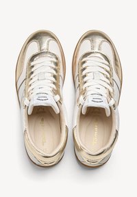 Paire de baskets métalliques blanches et dorées à lacets avec semelles intérieures rembourrées, vue du dessus sur fond blanc.