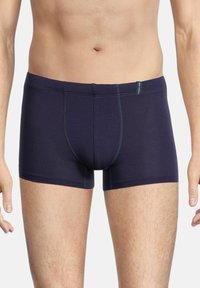 Dark navy boxer shorts made of soft fabric, featuring contrasting stitching and a snug fit, with an elastic waistband displaying the brand logo.