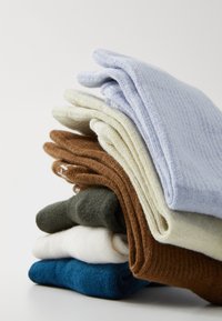 Set of five pairs of folded socks in varying colors: light blue, beige, brown, dark green, and navy. Made from soft, textured fabric.