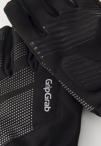Schwarze Handschuhe mit gummierten Grip-Bereichen, gepunkteten Mustern und dem "GripGrab"-Logo, hergestellt aus einem flexiblen, strukturierten Material.