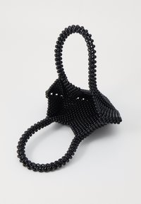 Black beaded bag with a geometric design, featuring two rounded handles and a textured surface, crafted from small cylindrical beads.