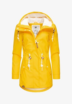 Geltonas vandeniui atsparus džemperis su baltu pūkų pamušalu. Yra užtrauktukas priekyje, raišteliai liemenyje ir veidrodinės sagos detalės.