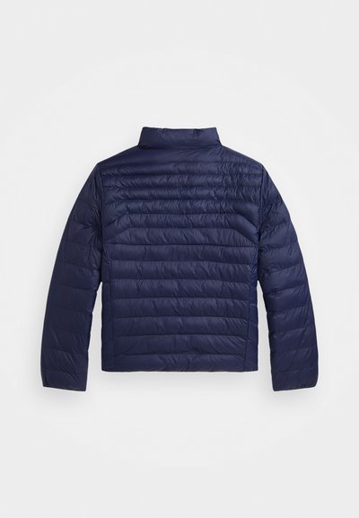 Tumši zila šūta pūkaina virsjaka ar garām piedurknēm un stāvus apkakli, redzama no aizmugures uz vienkārša balta fona.