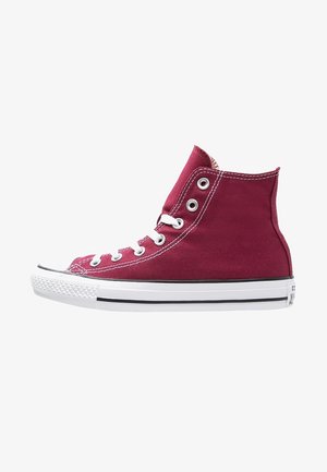 High-top sneakers in burgundy canvas with white laces and rubber sole, featuring black accents and metal eyelets. Classic design with textured surface.