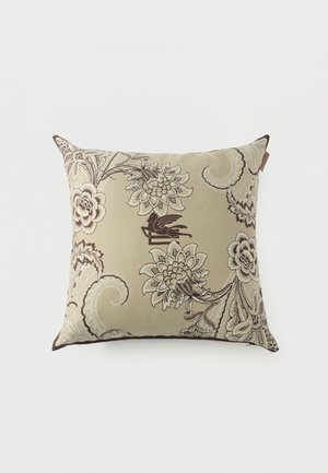 Square beige cushion with intricate dark brown and cream floral and scroll patterns on fabric cover.