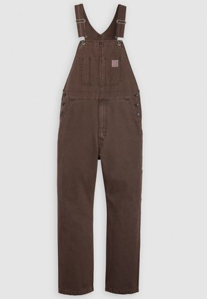 Brown denim overalls with adjustable shoulder straps, front chest pocket with label, side button closures, and straight leg fit.