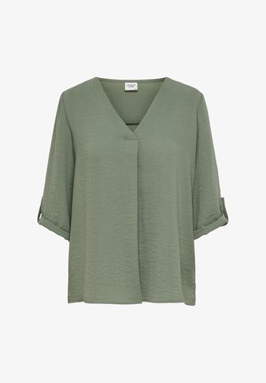 Lichtgroene blouse met korte mouwen en een V-hals. Geweven stof met een relaxte pasvorm. Opgerolde mouwen voegen detail toe. Eenvoudig ontwerp.