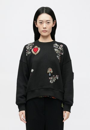 Black sweatshirt featuring intricate floral and heart embroidery in red, white, and gold. Ribbed cuffs and hem, relaxed fit.