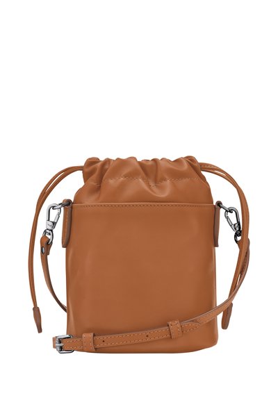 Tan leather drawstring bag with a smooth texture, adjustable shoulder strap, and shiny silver hardware detailing. Compact and minimal design.