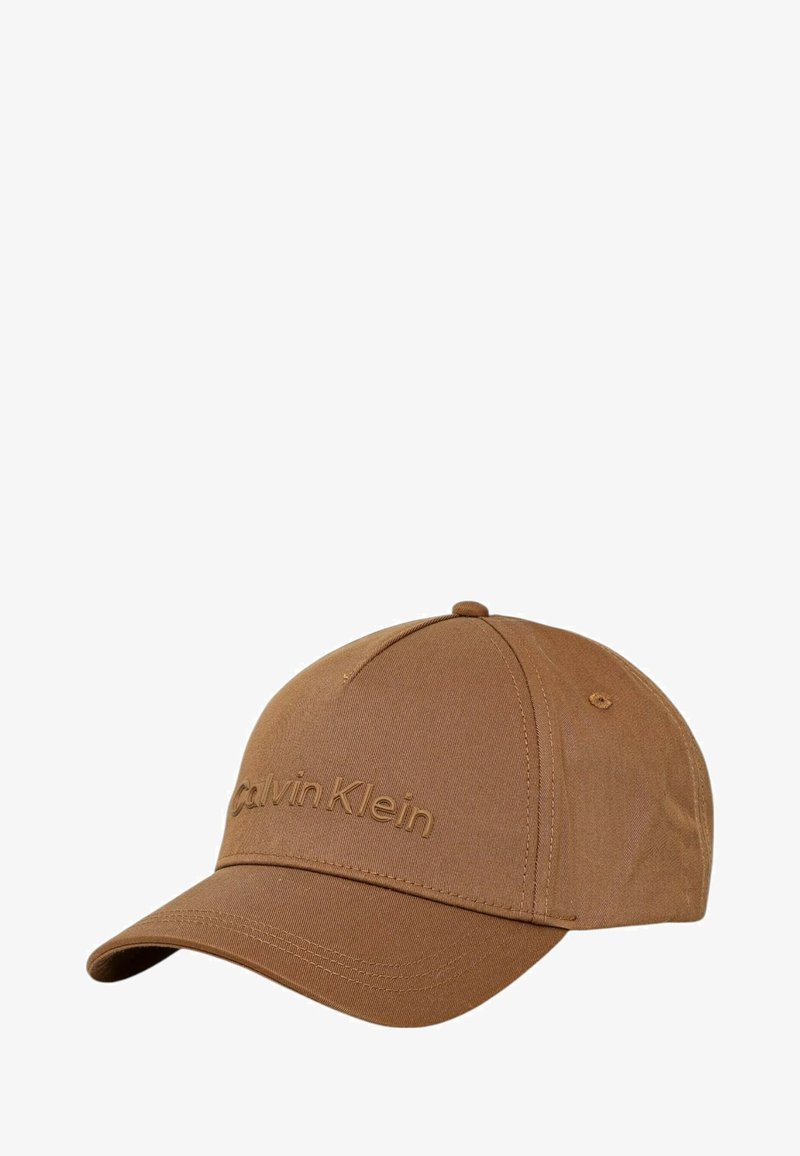 Brun baseballcap lavet af struktureret stof, med en buet skygge og prægede "Calvin Klein" logo på forsiden.