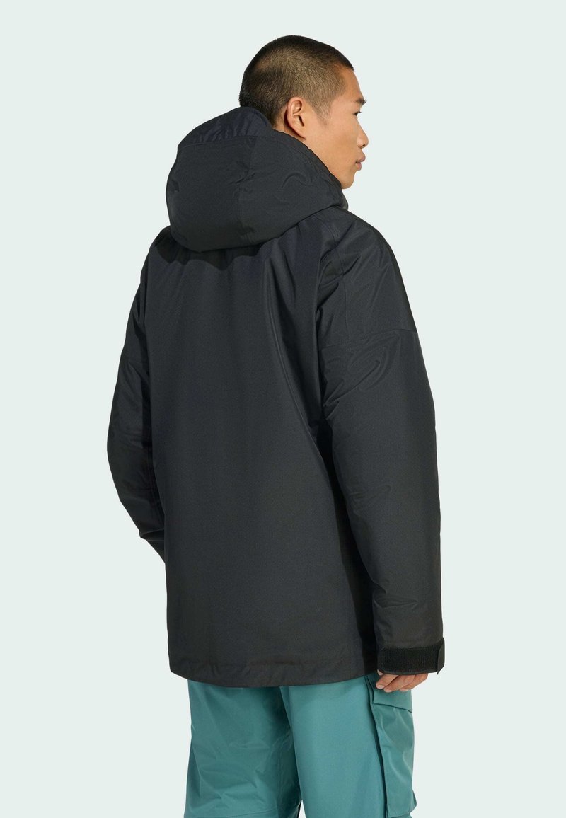 Schwarze Daunenjacke mit verstellbarem Kapuzen, schlankem Design und strukturiertem Stoff. Verfügt über elastische Bündchen und einen geraden Rückenschnitt.