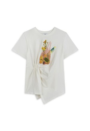 White cotton t-shirt featuring a knotted detail on the side, with a colorful graphic of a grocery bag and flowers on the front.