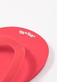 Red rubber flip-flop featuring a textured strap and a smooth footbed. The logo "flip * flop" appears in white on the side.