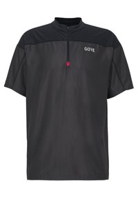 Černé cyklistické dres s krátkým rukávem a polo-zip krkem, zdobený texturovaným vzorem, logem GORE a růžovým akcentem na táhle zipu.